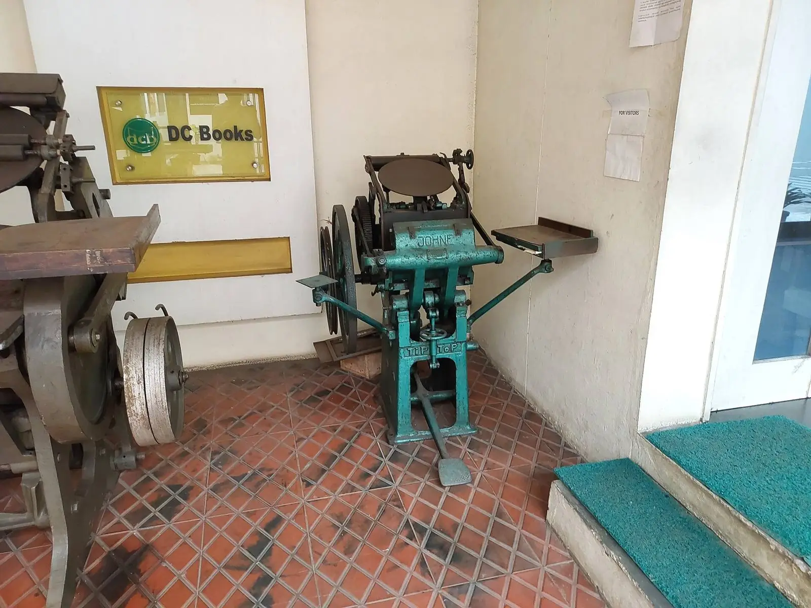 A cast iron printing press with its platen and ink rollers